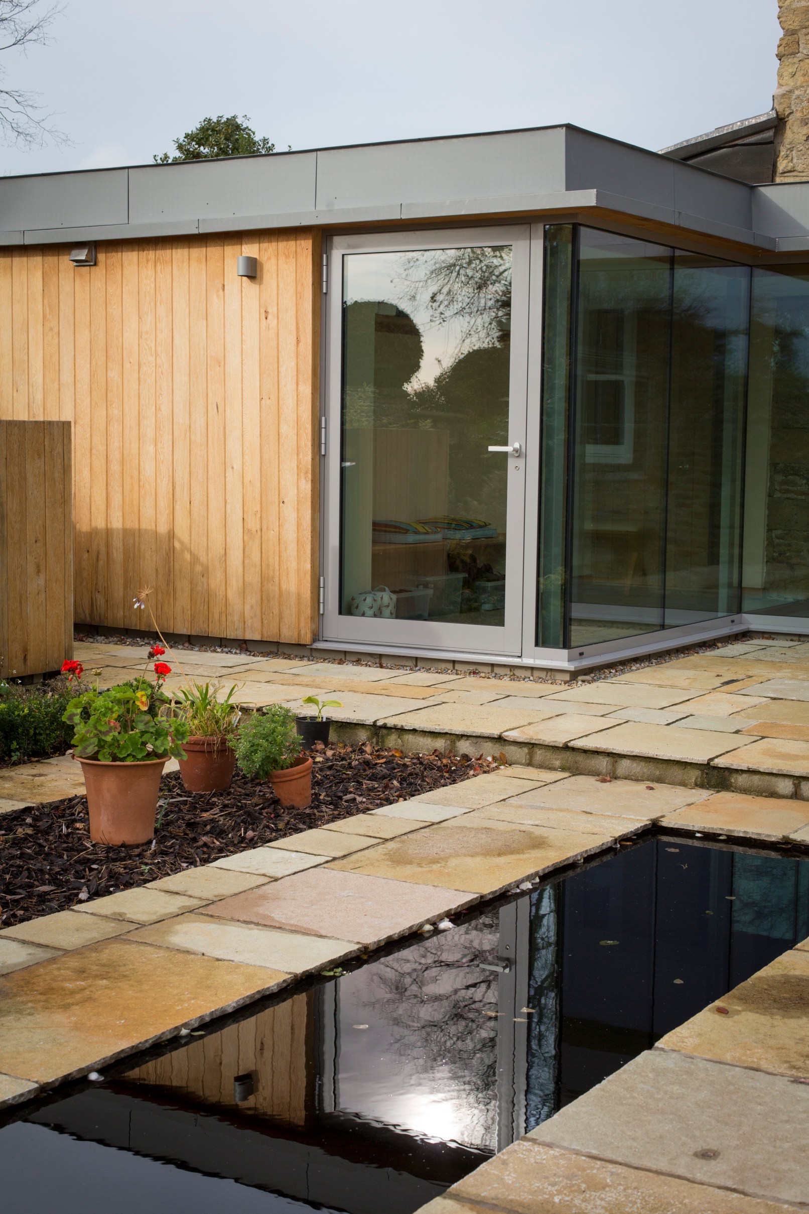 Church Lane Cottage, Hutton Buscel, Scarborough. Contemporary re-modelling and extension to Grade II listed cottage. Completion Photo with Reflection Pond