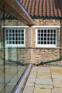 Church Lane Cottage, Hutton Buscel, Scarborough. Contemporary re-modelling and extension to Grade II listed cottage. External reflection